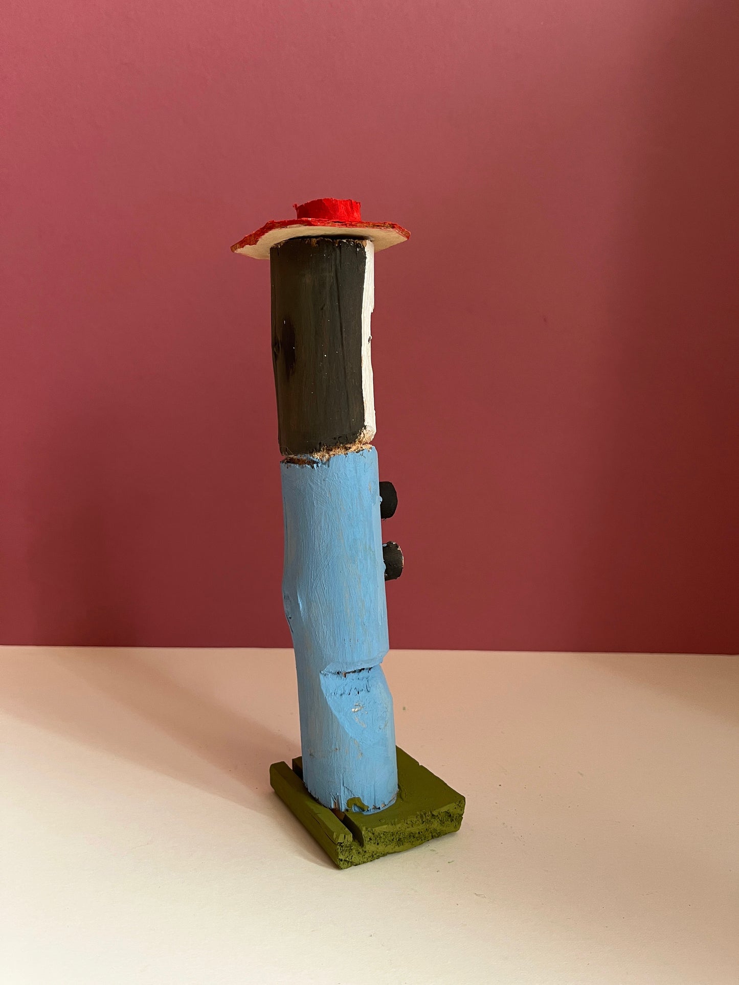 Figure with a Red Hat by Dionizy
