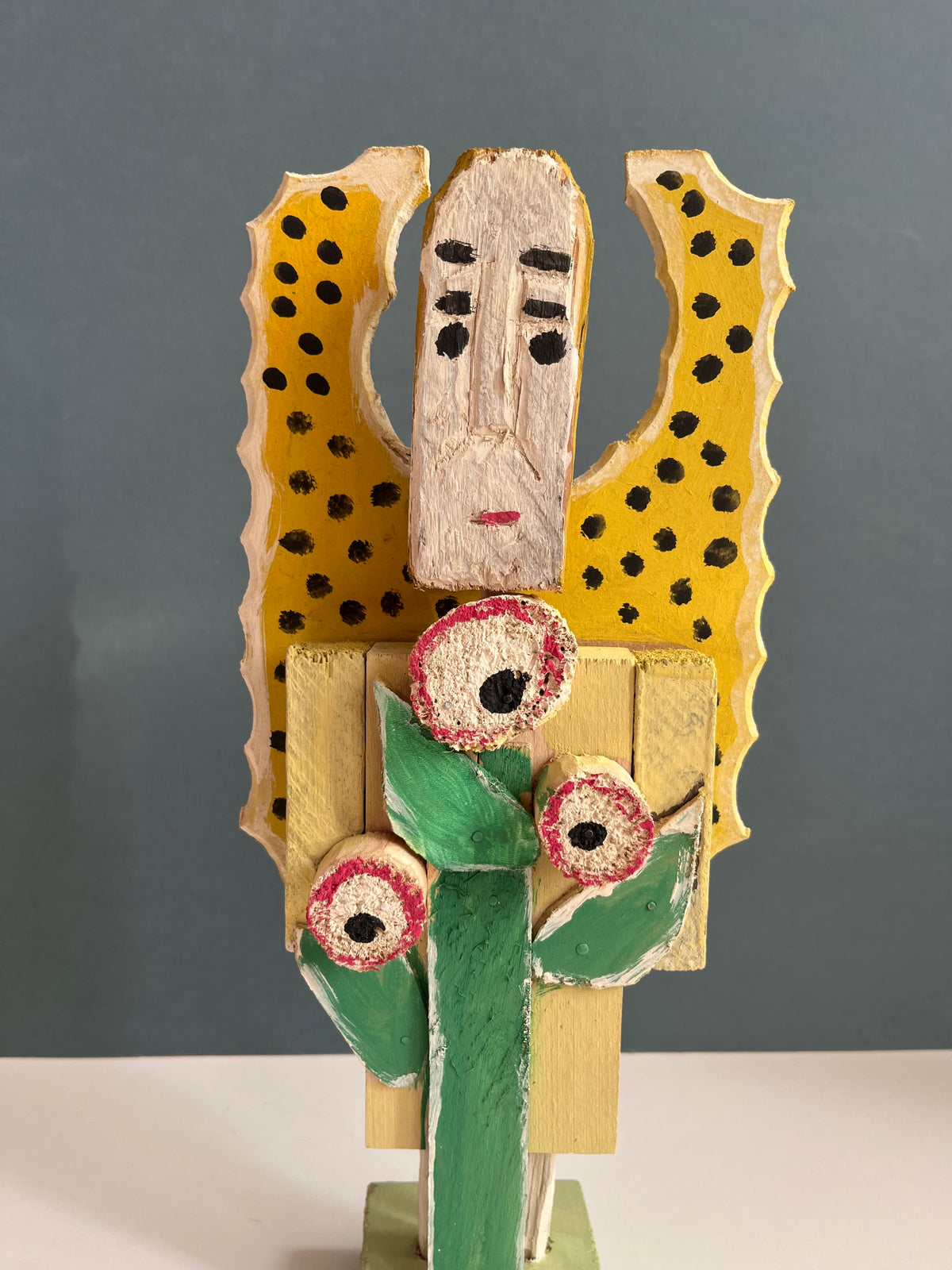 Wooden Figure with a Flower by Dionizy