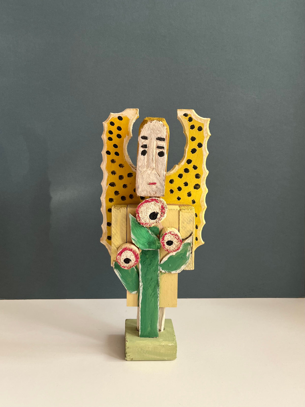 Wooden Figure with a Flower by Dionizy