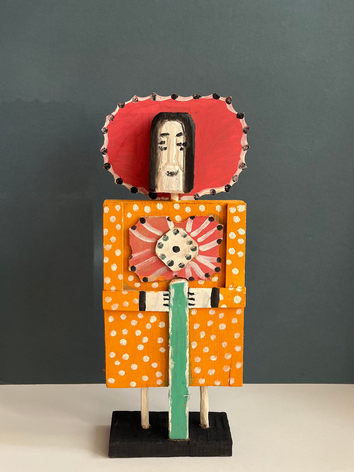Wooden Figure with a Red Flower by Dionizy
